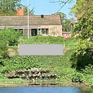 Den døde grav ved Nyborg Vold - grå skraveret felt over blomsterbedet